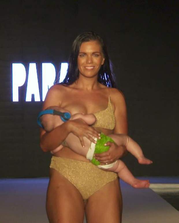Mara Martin breastfeeds while walking the #SISwimSearch Runway